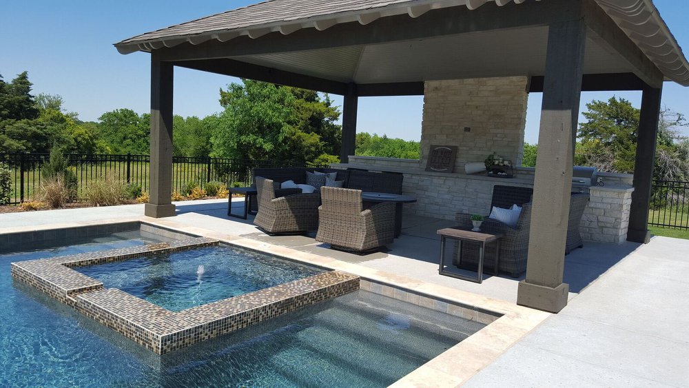Covered kitchen and seating area beside a pool, from the King Pools archive
