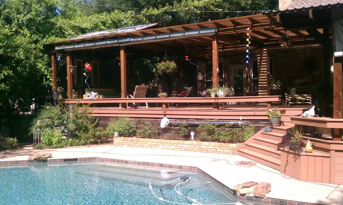 Wood pergola and deck connecting outdoor seating to the house